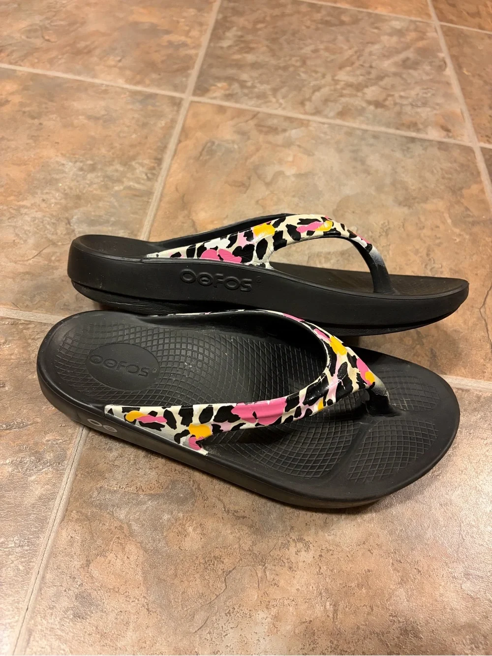OOFOS Women's Black Flip Flop Sandals with Pink & Yellow Accent Straps